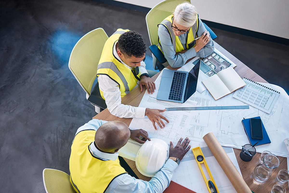 manufacturing team working on blueprint